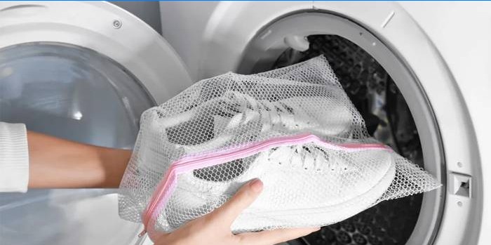 Witte sneakers in een tas om te wassen