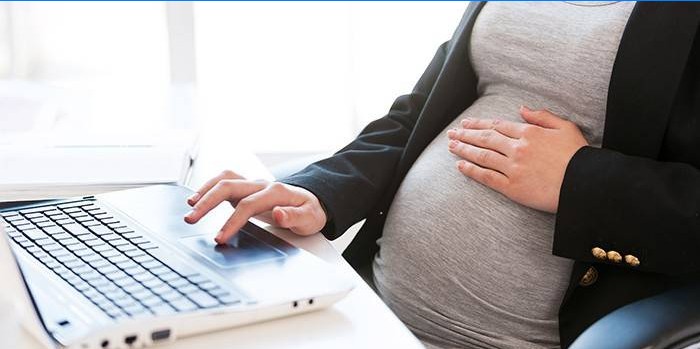Zwangere vrouw op een laptop